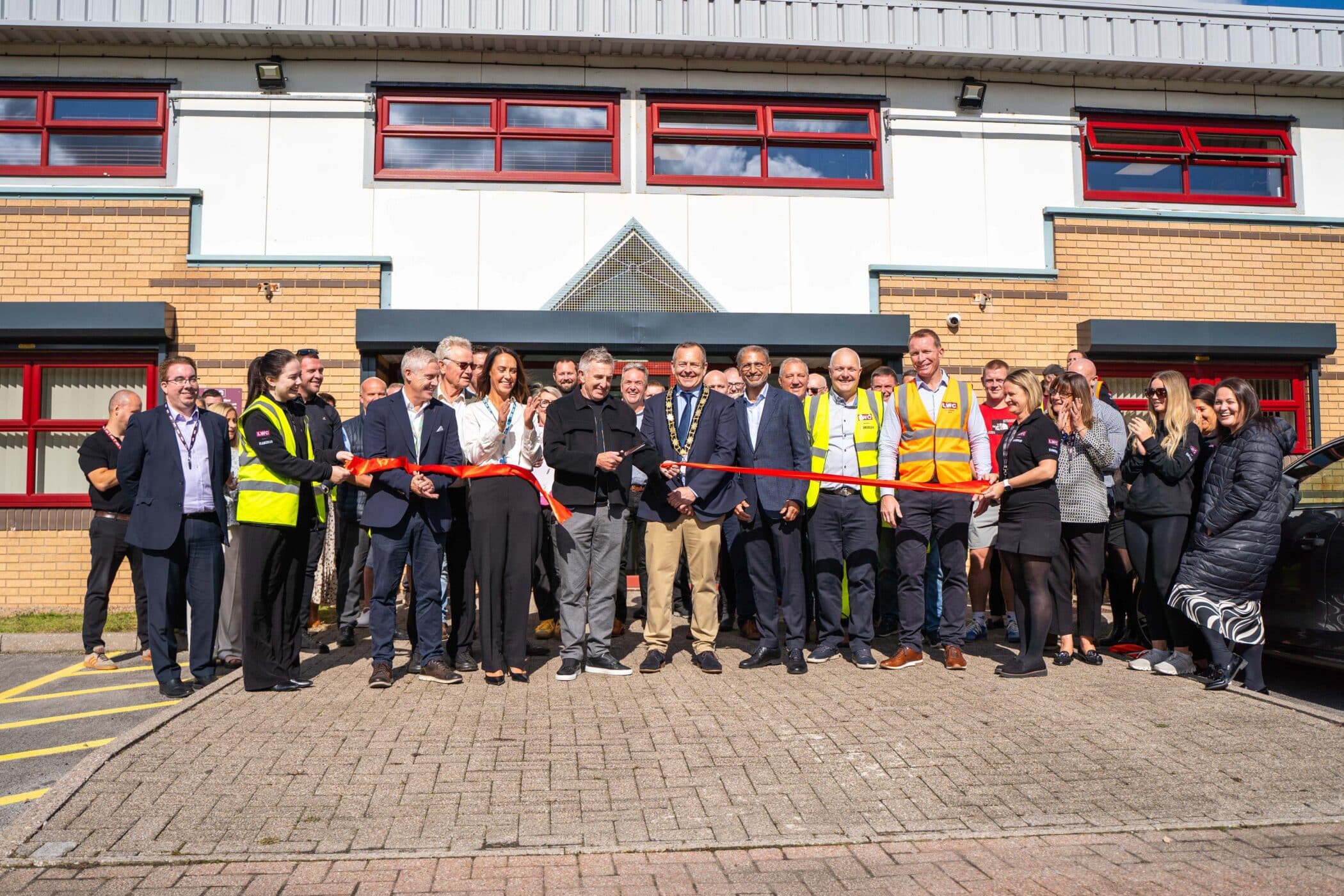 Image of people outside the Glamorgan depot, with the Mayor cutting a ribbon